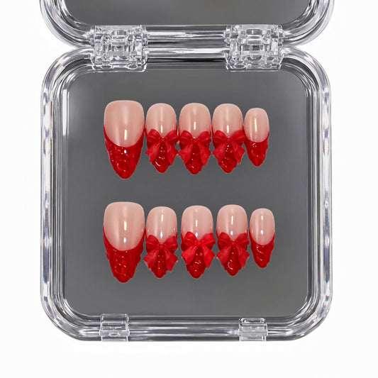 Ruby Kiss medium almond red French tip press-on nails with 3D bows