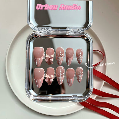 Frosted Pink Snowflake press-on nails in almond shape, medium length