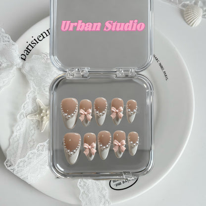 Pearl Bow Nude French press-on nails in almond shape, medium length – detail view 2